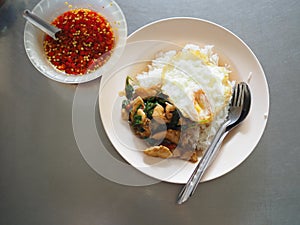 Top view of Thai local stir fried chicken with holy basil. with deep fried egg, with fish sauce