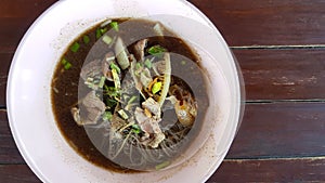 Top view of Thai rice noodle with beef, stale meat, liver, cow rag, offal and on brown wooden background or table and copy space