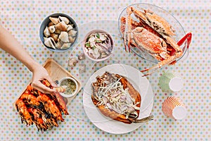 Top view of Thai Seafoods are Grilled Prawns Shrimps in the shell, Steamed crabs, grilled Laevistrombus Canarium, Grilled Squid.