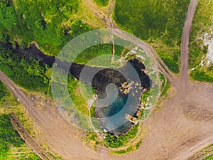 Top view of a thin river and fields around it.