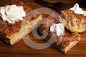 Top view of Three Churro Cheesecake pieces and a drink on a wooden base