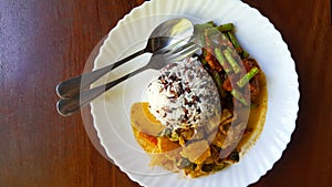 Top view of Three color rice with spicy yellow curry with pork and Stir fried pork belly and red curry paste with string bean