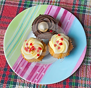 Top view of three cupcakes on the plate
