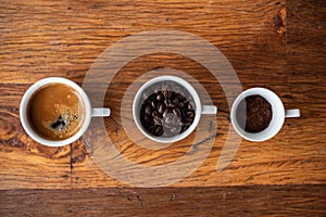 Top view of three different varieties of coffee on wooden background