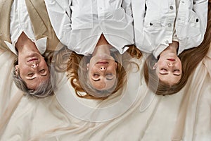 Top view of three generations of women sleep see dreams