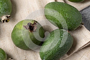 Top view of three green feijoa berries of different shapes. Tropical fruit for smoothies, am