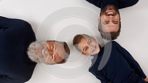 Top view of three male generations pose together