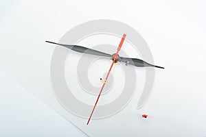 Top view of three people figures near clock arrows on white surface photo