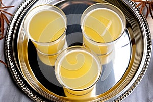 top view of three whiskey sours on a silver tray