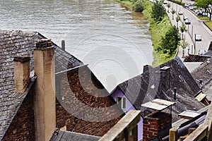 Top view of the tiled roofs of the medieval houses, the river Mosel and the road with cars