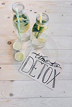 top view of time to detox card and detox drinks with citrus