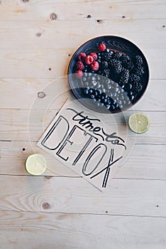 top view of time to detox card and organic berries on plate