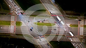 Top view to District streets in the night. Camera moving just above skyscrapers showing modern buildings, streets and crossroads