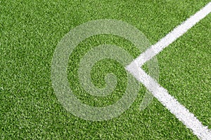 Top view to green artificial soccer football field grass with white line