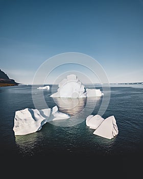 Top view to iceberg in Greenland breaking of Glacier. Top and underwater parts of Iceberg. Aerial Drone view. Ilulissat