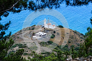 Top view to lighthouse, Turkey. Deep blue sea, lighthouse, trees.