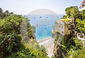 Little beach Spiaggia la Porta with the luxury yachts in Positano, Italy photo