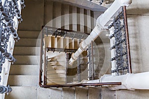 Top view to old castle indoor stair with wood handrail