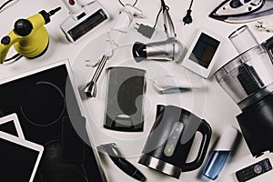 Top view to old household, electrical appliances, broken computers, tablets, phones, used electronic gadgets devices on