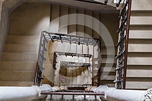 Top view to old stone castle indoor stair with wood handrail