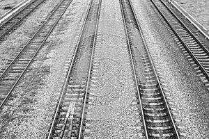 Top view to railway tracks close-up. Black and white photo.