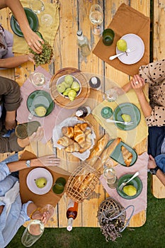 Top view of toasting wine above wooden table