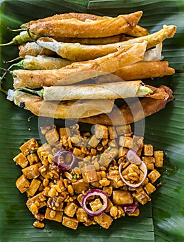 Top view of Tofu in peanut garlic sauce and Dynamite lumpia. Philippine appetizers or food usually served with beer photo