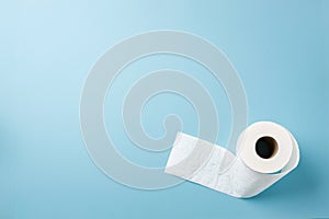 Top view of toilet paper roll on blue background