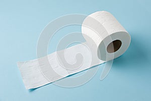 Top view of toilet paper roll on blue background