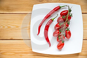 Top view tomatos, chilly pepper on wood background with copyspa