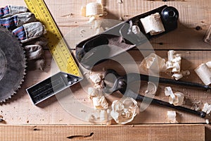 Top view of the tools of a carpenter, a roofer, for woodworking. plane, corner, wire cutters, gloves, drive from the grinder on a