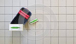 Top view of tools for grouting ceramic tiles. Tilers using a rubber trowel and sponge