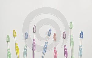 Top view of toothbrushes in colorful on pastel color background