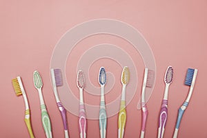 Top view of toothbrushes in colorful on pastel color background