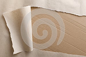 Top view of torn wrapping paper and side of paperboard box.Empty space for text.Opening parcel