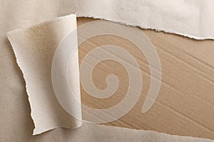 Top view of torn wrapping paper and side of paperboard box.Empty space for text.Opening parcel photo