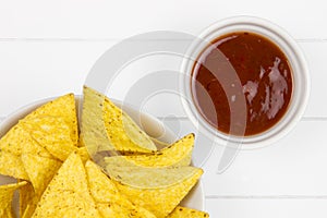 Top-view of tortilla chips with salsa sauce