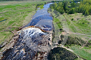 Top view of the Tosnensky Gertovsky waterfall on an April day. Ulyanovka, Leningrad Region. Russia