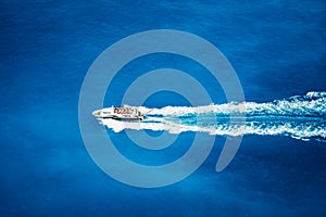 Top view of tourist boat sailing in the sea on full speed