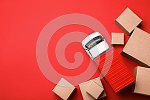 Top view of toy truck with boxes on background. Logistics and wholesale concept photo