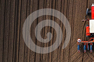 Top view of tractor planting corn seed in field