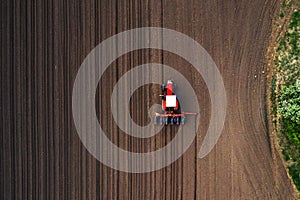 Top view of tractor planting corn seed in field