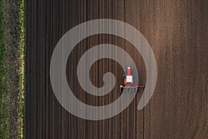 Top view of tractor planting corn seed in field
