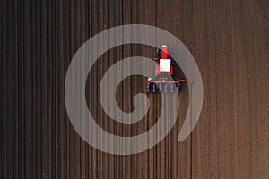 Top view of tractor planting corn seed in field