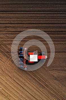 Top view of tractor planting corn seed in field