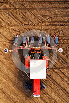 Top view of tractor with seeder from drone pov