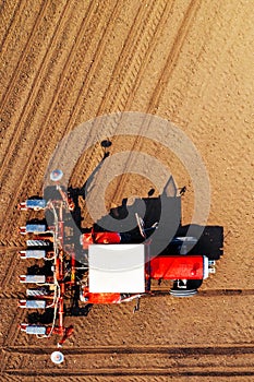 Top view of tractor with seeder from drone pov