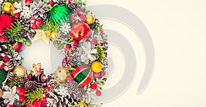 Top view traditional bright Christmas wreath decorated with pine cones, spruce branches,berries, balls, stars, decorative beers on