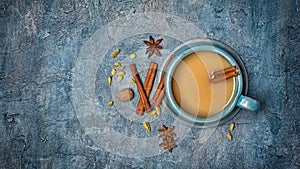 Top view on traditional indian drink masala chai tea with milk and mix of spices