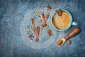 Top view on traditional indian drink masala chai tea with milk and mix of spices